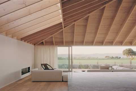 Warm Wood Finishes Sandwich the White Interiors of a Coastal Home in New Zealand